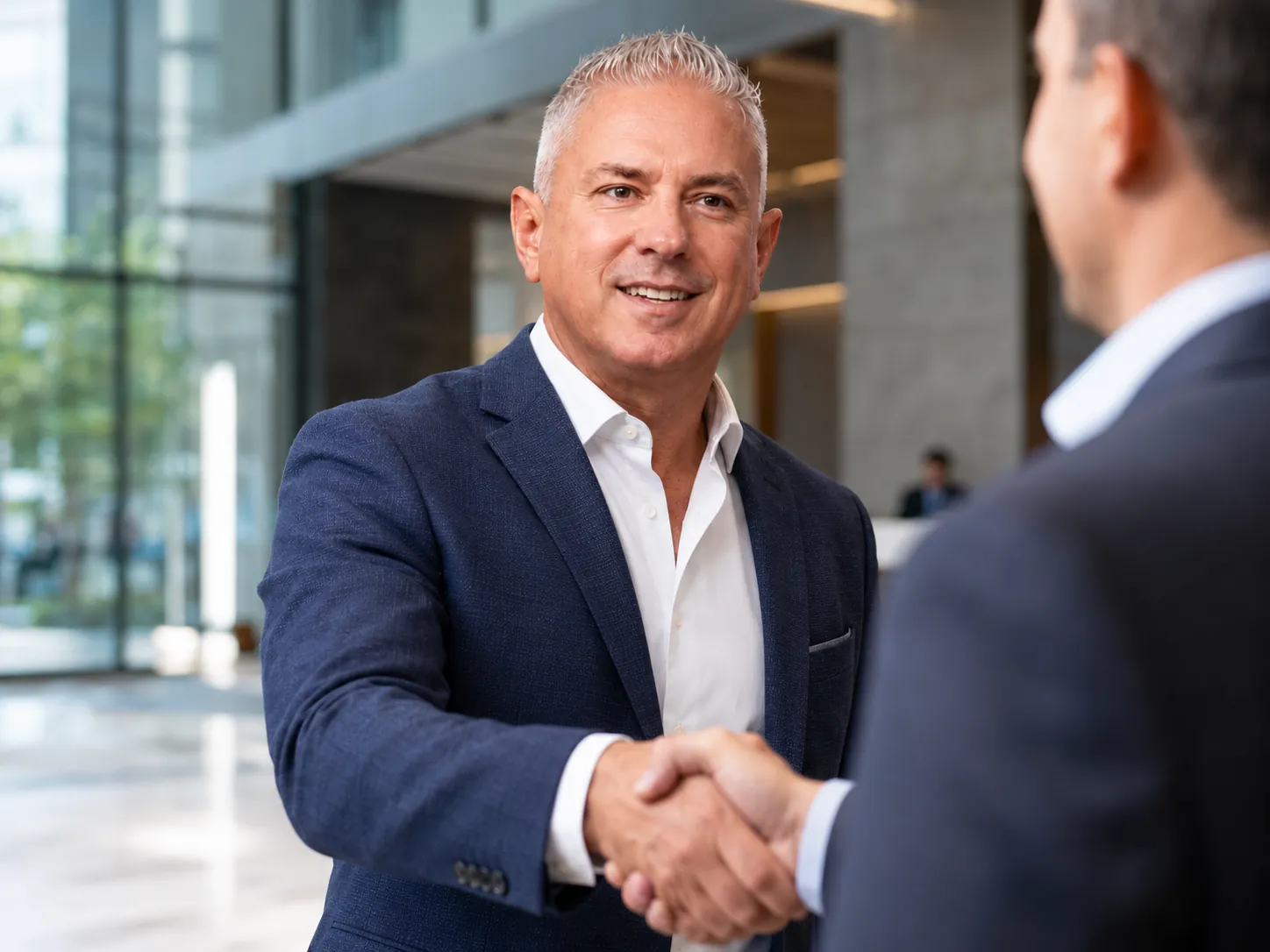 David Gembala, commercial roofing executive, shaking hands at a business meeting